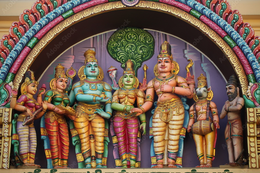 bright figures of the gods on the gopurama of a hindu temple in sri lanka