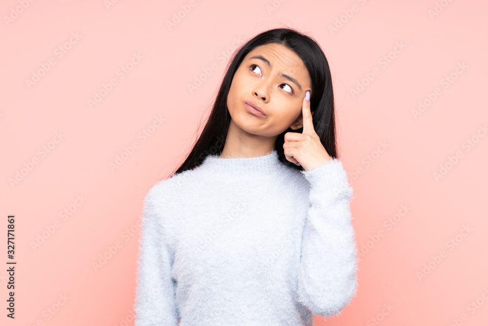 Teenager Chinese woman isolated on pink background with problems making suicide gesture Teenager Chinese woman isolated on pink background with problems making suicide gesture