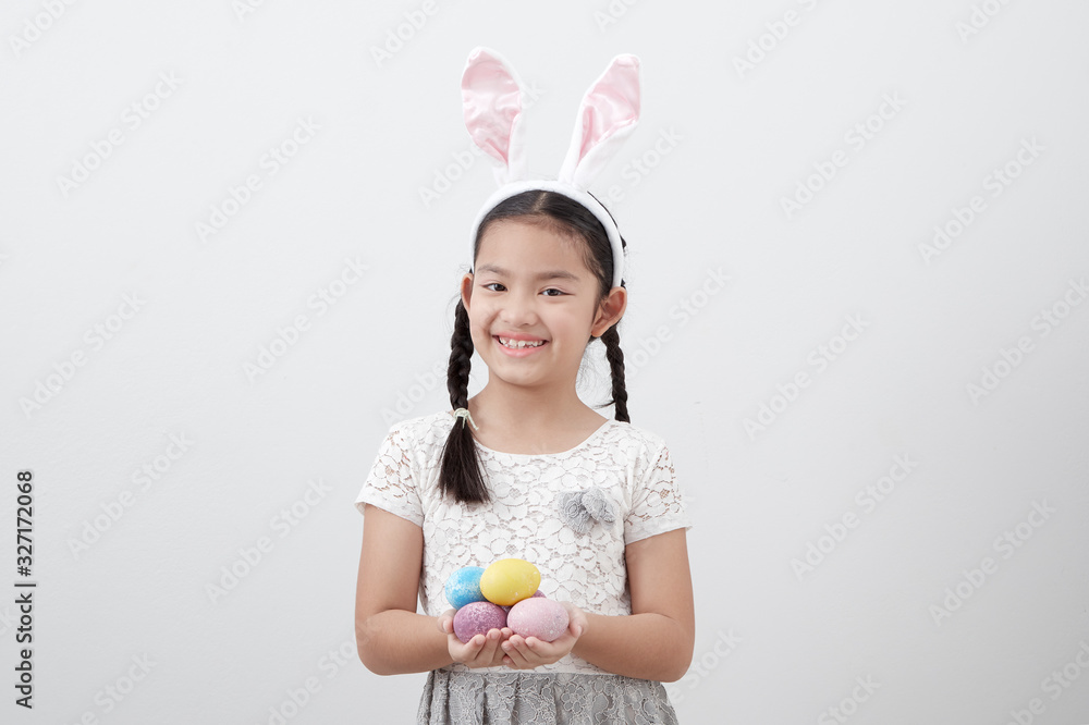little child girl with easter bunny ears holding egg little child girl with easter bunny ears holding egg