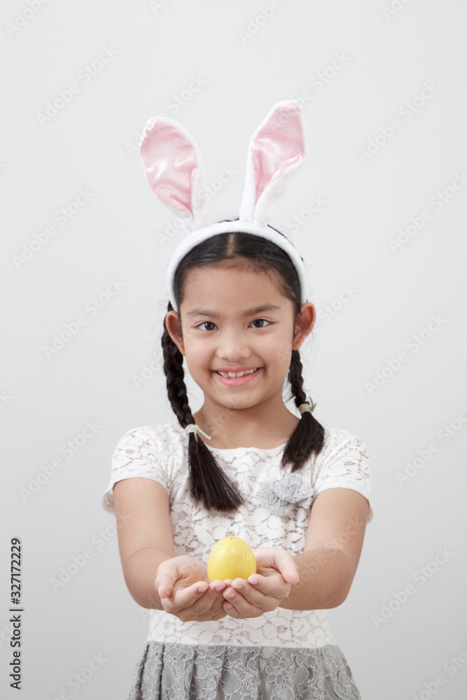 little child girl with easter bunny ears holding egg little child girl with easter bunny ears holding egg