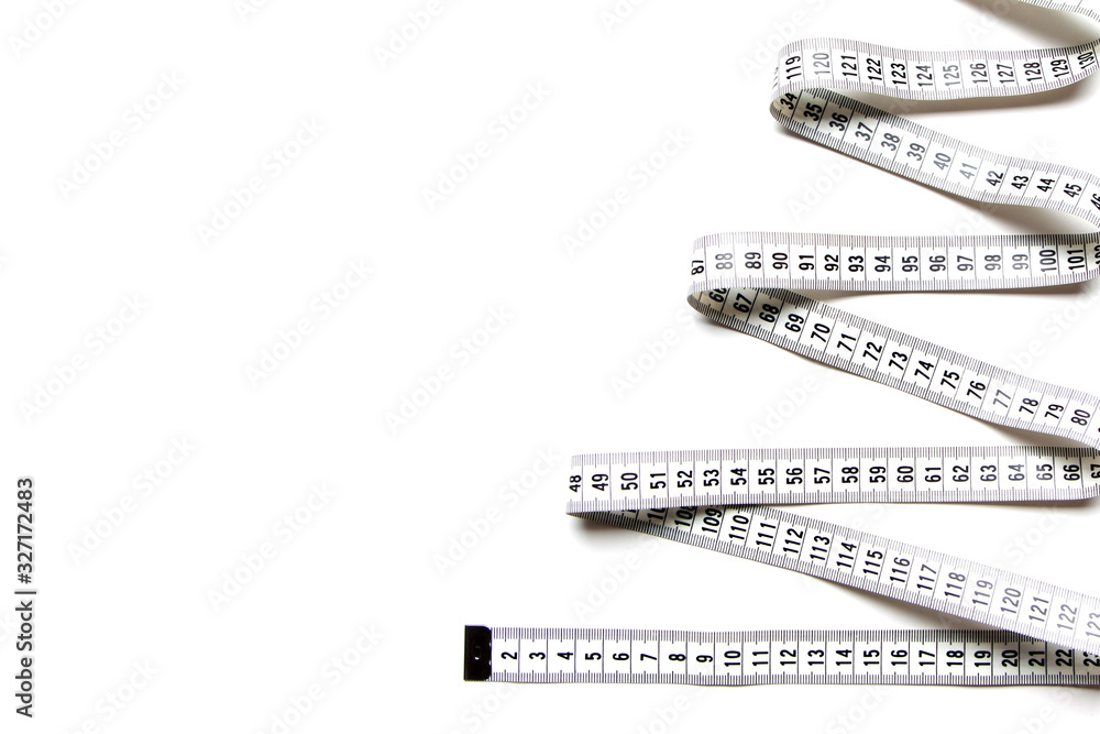Fototapeta premium The figure is spiral of a centimeter tape. Isolate measuring tape on a white background.