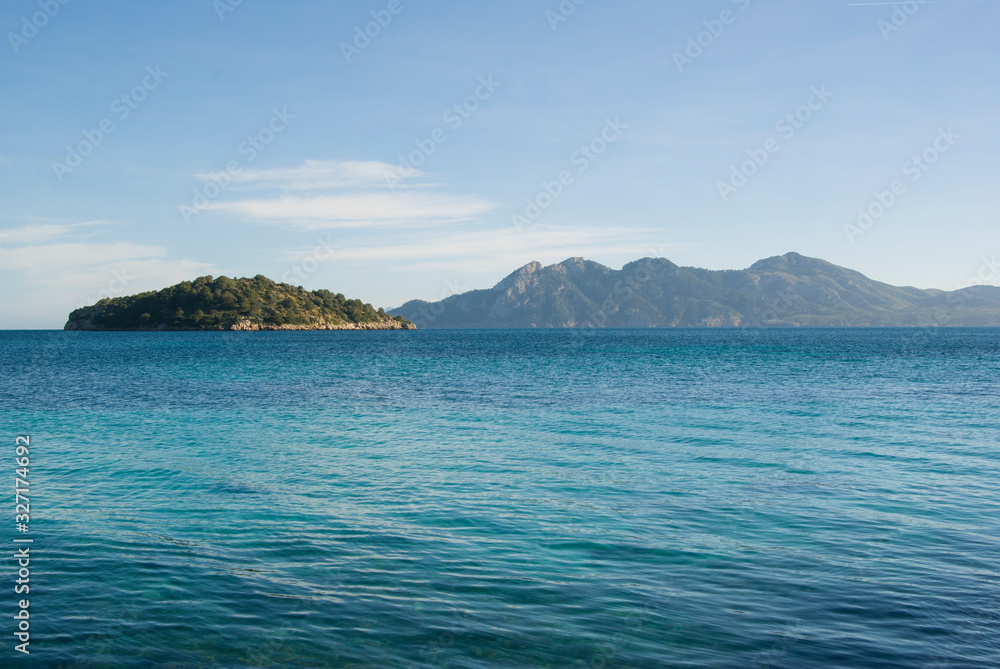 Mallorca landscape on a sunny day. Beach with turquoise water and view of the islands. Majorca, Spain