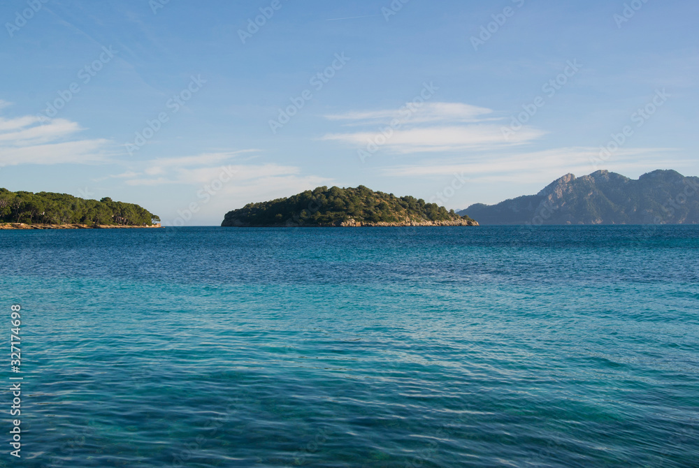 Mallorca landscape on a sunny day. Beach with turquoise water and view of the islands. Majorca, Spain