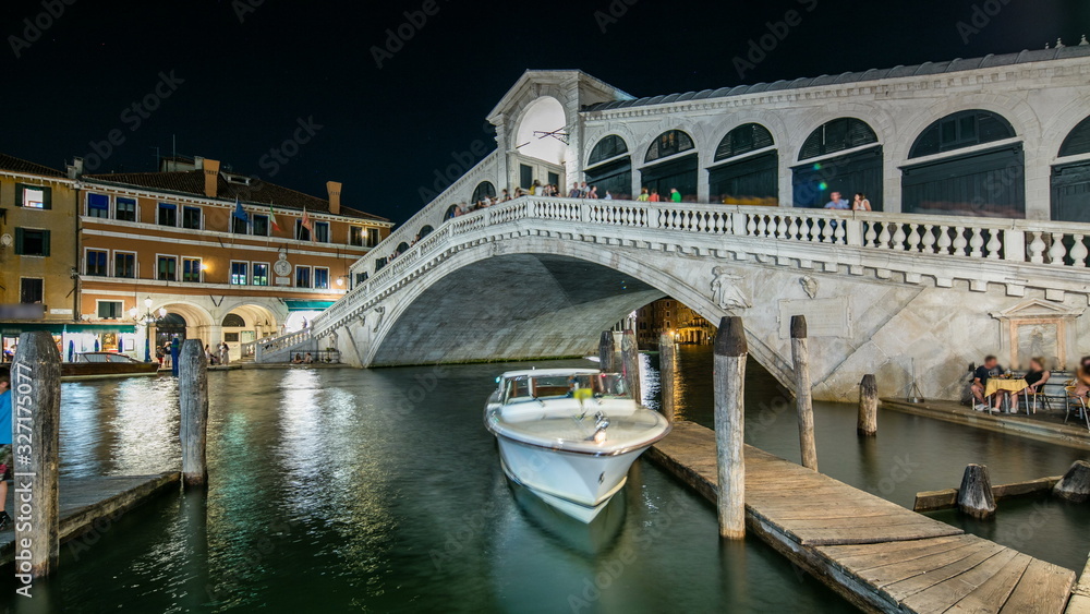 Rialto Bridge or Ponte di Rialto over Grand Canal timelapse at night in Venice, Italy.