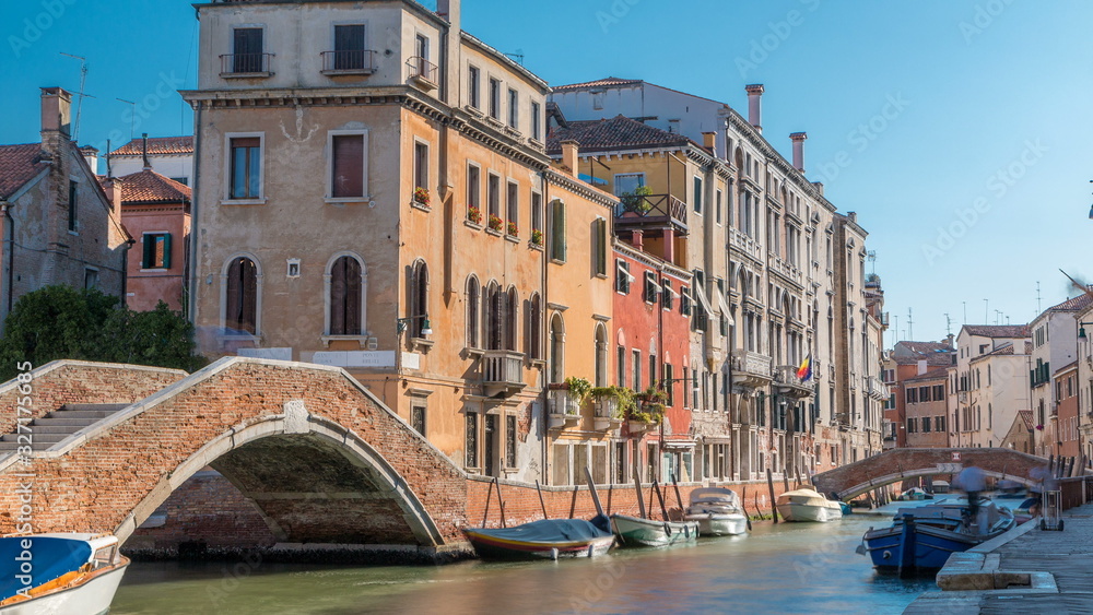 Naklejka premium Morning in Venice timelapse. Canal channel , bridges, historical, old houses and boats. Venice, Italy