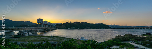 Panorama of the sunset scene of Chilgokbo Dam across the Nakdong River in Gyeongsangbuk-do, South Korea photo