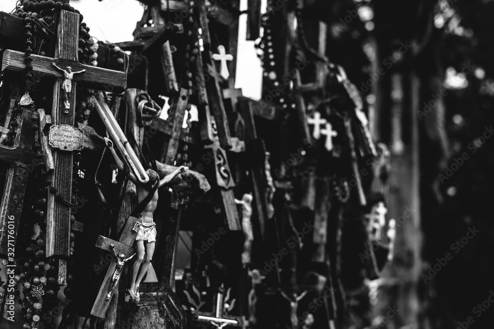 Numerous crucifixes on the hill of crosses in Lithuania. Black and white. Concept of death, despair, and destruction. Numerous crucifixes on the hill of crosses in Lithuania. Black and white. Concept of death, despair, and destruction.