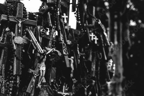 Numerous crucifixes on the hill of crosses in Lithuania. Black and white. Concept of death, despair, and destruction. © Yurii Zymovin
