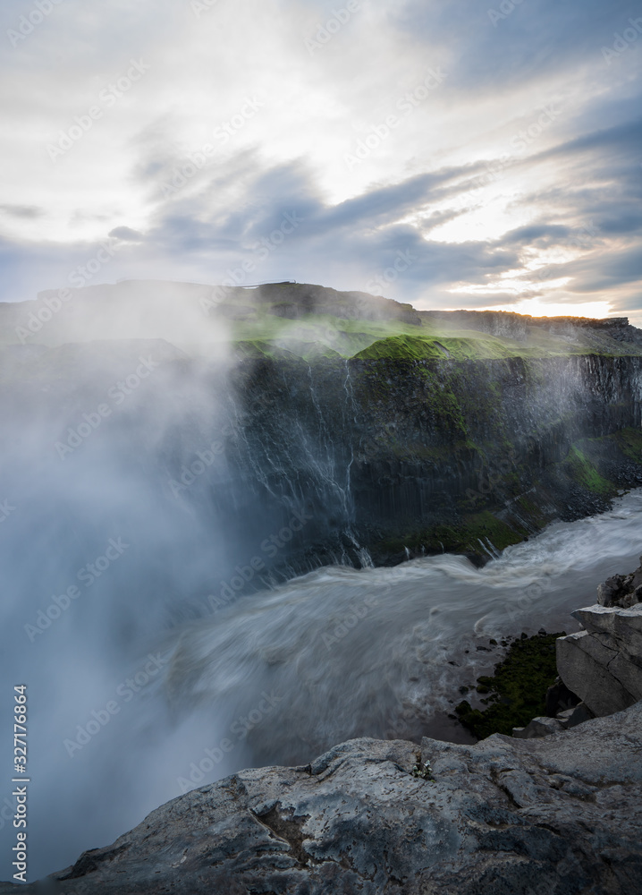 River leading away from the mighty dettifoss,  with steam in the background iceland, sunset