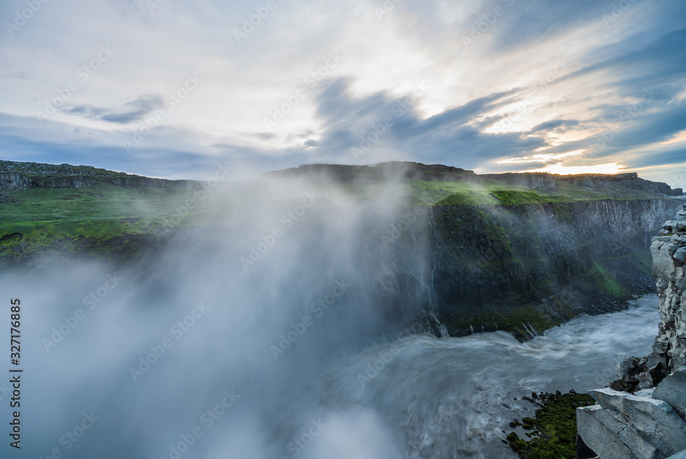River leading away from the mighty dettifoss,  with steam in the background iceland, sunset