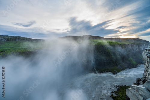 River leading away from the mighty dettifoss, with steam in the background iceland, sunset