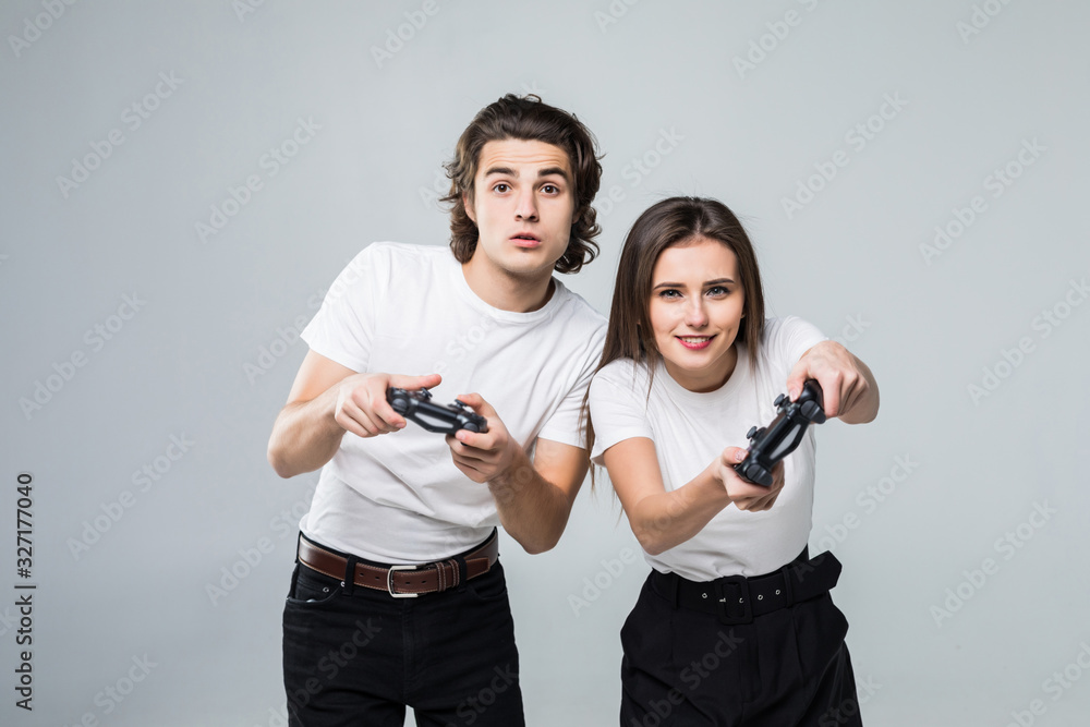 Married young people are fans of video games, love spending their weekend together on light background Married young people are fans of video games, love spending their weekend together on light background