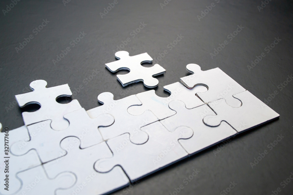 White puzzles on a black background close-up White puzzles on a black background close-up