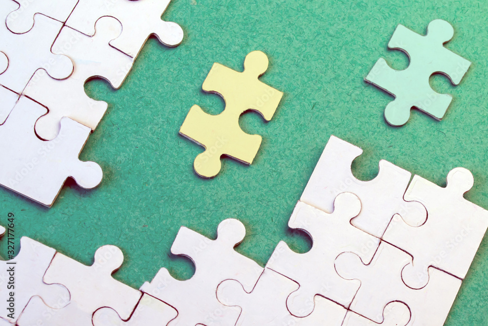 Yellow and Green puzzle moves to white puzzles on a green background Yellow and Green puzzle moves to white puzzles on a green background