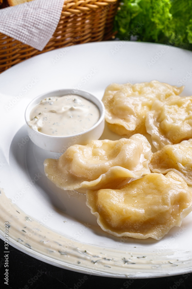 traditional Ukrainian dish of dumplings with sour cream traditional Ukrainian dish of dumplings with sour cream