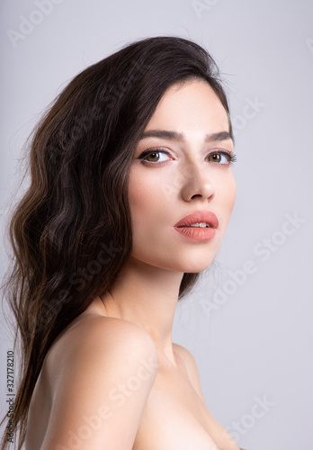 Woman with beauty brown hair. Portrait of brunette woman with beautiful hairstyle. Fashion model, at studio. Beautiful young woman with long brown hair. Clean fresh clean skin face.