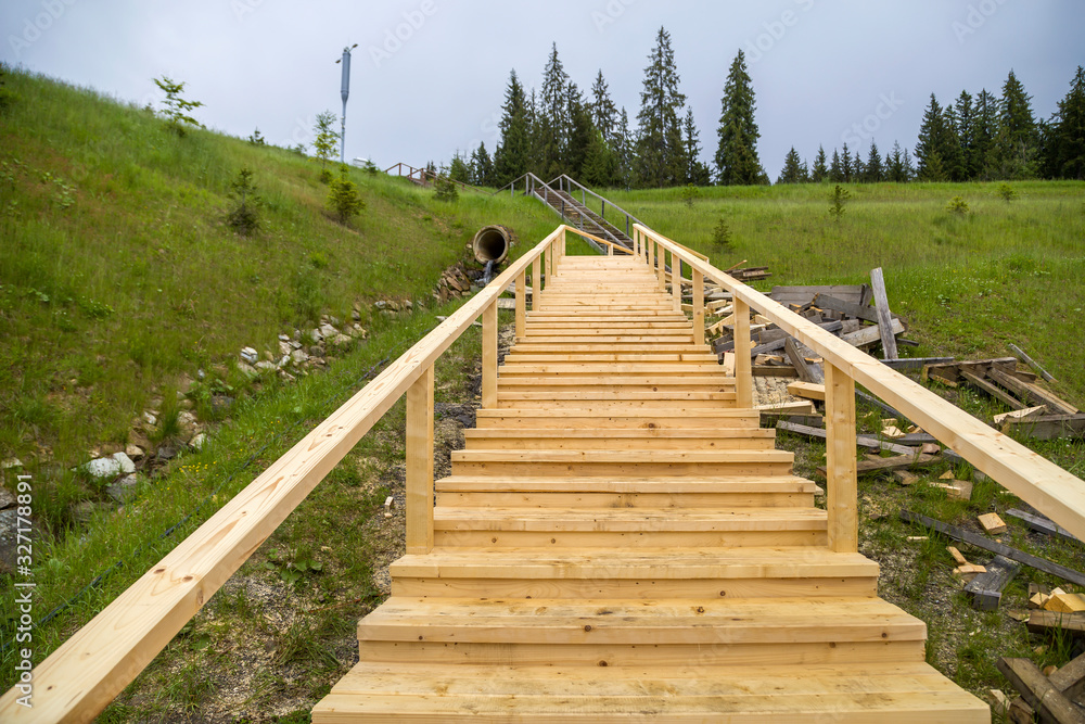 Obraz premium New wooden stairs outdoors. Carpenters work.