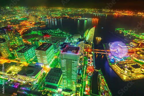 Fototapeta Naklejka Na Ścianę i Meble -  Panoramic view of Yokohama Skyline and Minato Mirai waterfront district with ferris wheel by night from viewing platform, observatory sky garden of Landmark Tower.