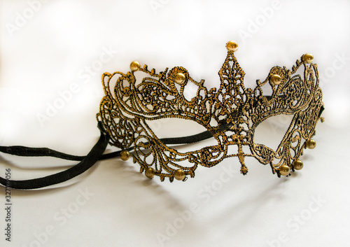 golden mask with embroidery on a white background