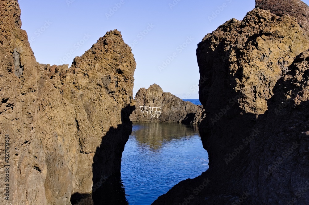 Natural pool with black volcanic rock in the Atlantic Ocean (Madeira, Portugal, Europe)