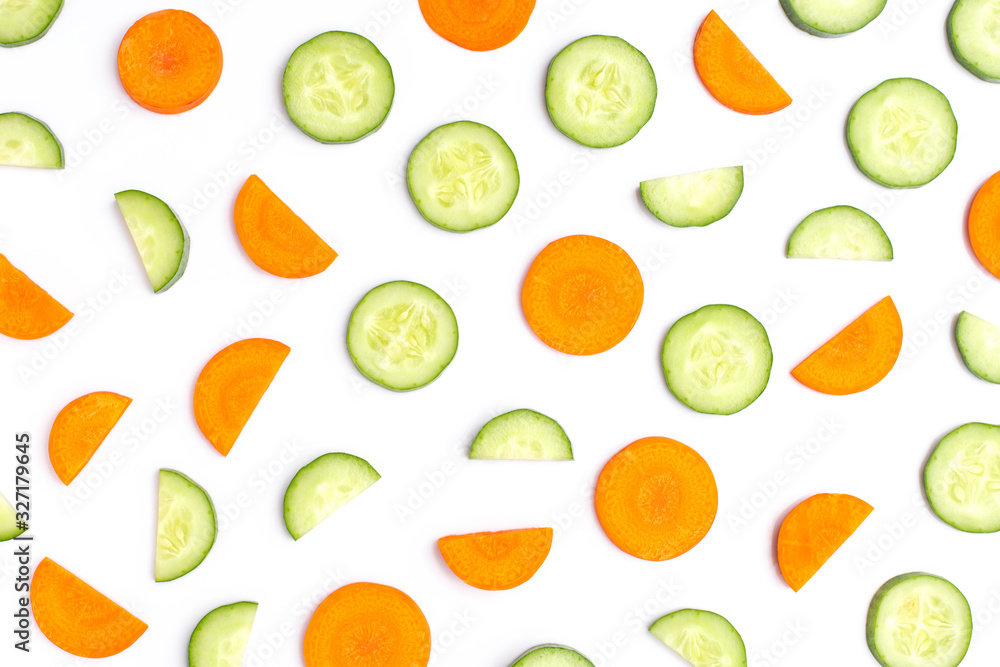 Cucumber and carrot slices isolated on white background. Top view. Flat lay. Cucumber and carrot slices isolated on white background. Top view. Flat lay.