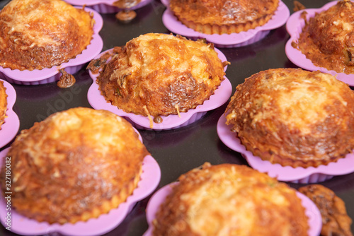 cupcakes in pink silicon moulds, on a black tray