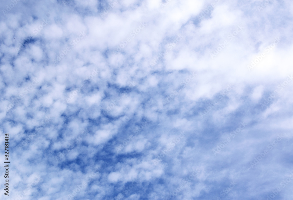 Blue sky background with tiny clouds. Beautiful clouds on blue sky Blue sky background with tiny clouds. Beautiful clouds on blue sky