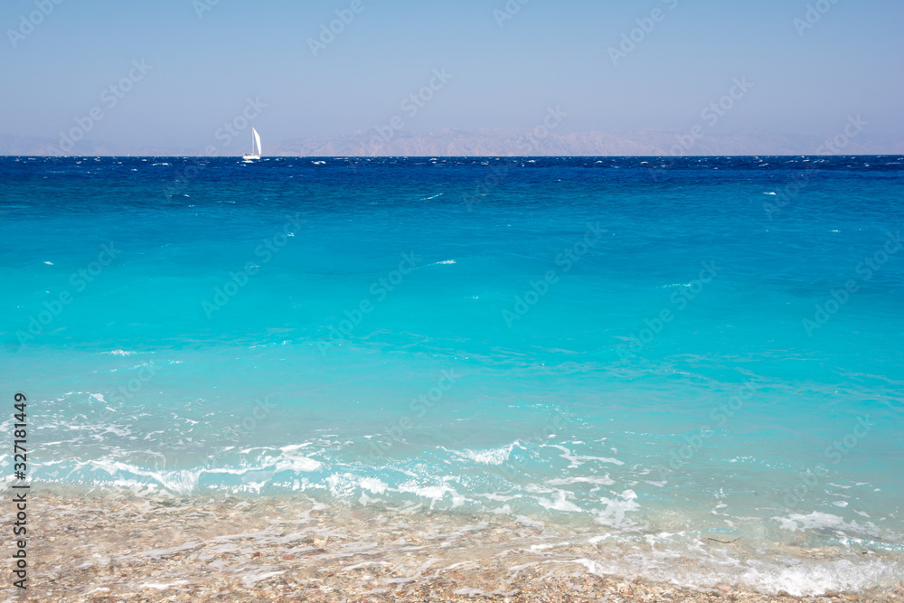 Turquoise water of mediterranean sea on Elli beach on Rhodes island in Greece