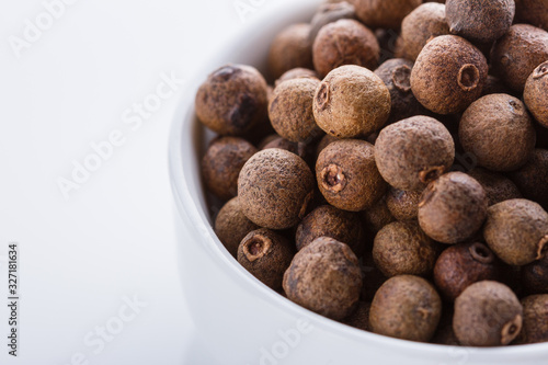 fresh spicy peppers allspice on white acrylic background