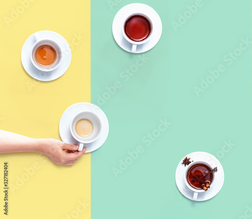 Female hand holding a tea cup overhead view - flat lay