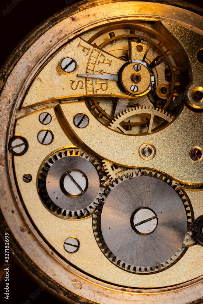 Close up of an authentic 100 hundred years old pocket watch mechanism cogs and wheels , golden Close up of an authentic 100 hundred years old pocket watch mechanism cogs and wheels , golden