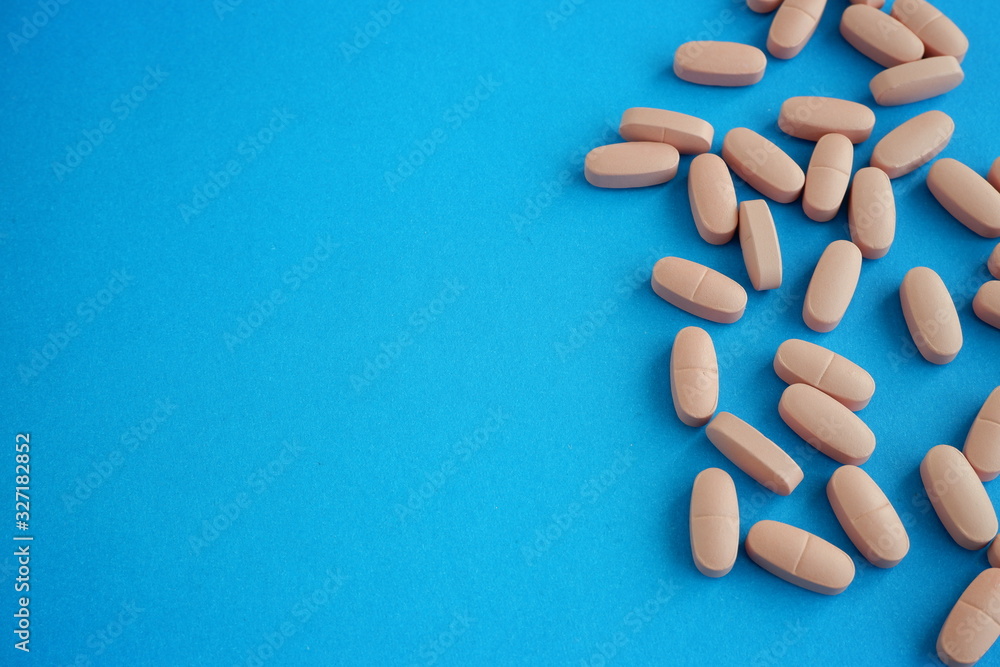Pills on a blue background. Treatment for the virus. Pills on a blue background. Treatment for the virus.
