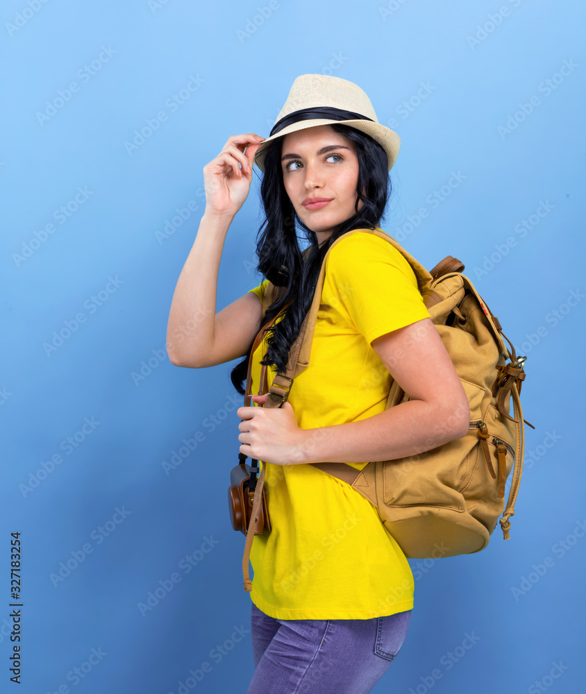 Happy young woman hiking on a blue background Happy young woman hiking on a blue background