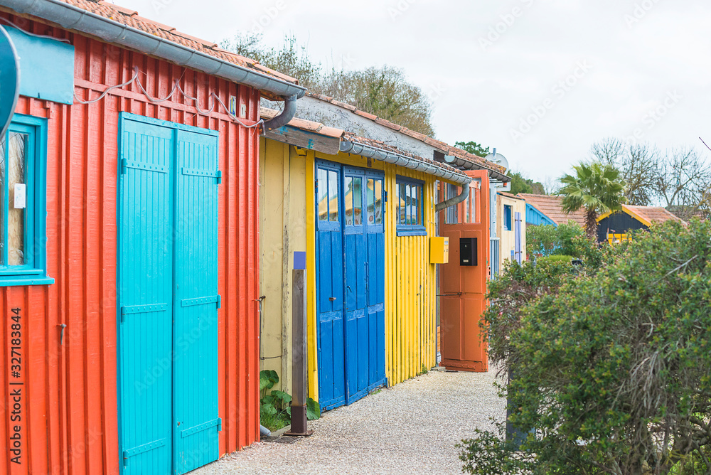 Multicolored fisher's huts on coastline of Atlantic ocean