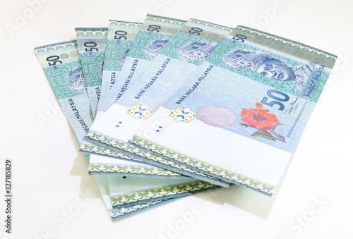Malaysia Currency (MYR): Stack of Ringgit Malaysia bank note. There is a Malaysia banknotes in (MYR)50 isolated on white background