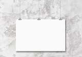 blank poster hanging on a white background painted walls