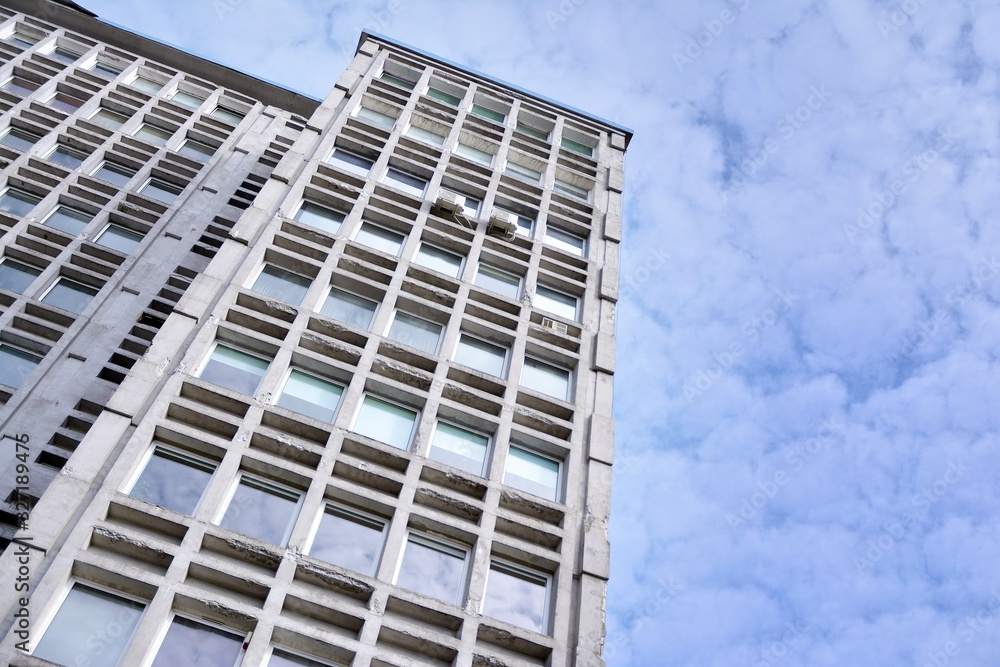 Facade of an old industrial office building with a predominance of old cement and old structural elements. Facade of an old industrial office building with a predominance of old cement and old structural elements.