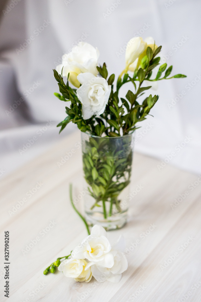 white freesia flowers in a glass white freesia flowers in a glass