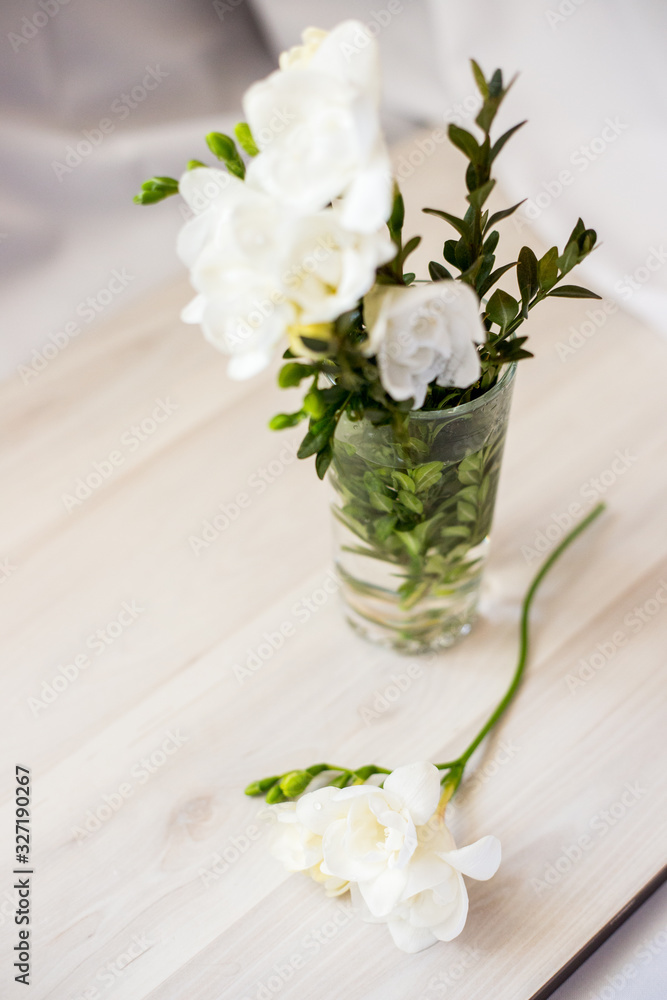 white freesia flowers in a glass white freesia flowers in a glass