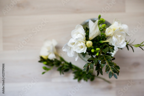 white freesia flowers in a glass