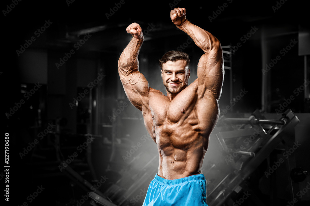 good looking fitness man pumping up muscles
