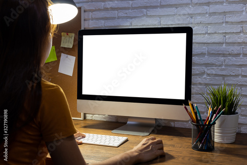 woman working empty screen computer mockup on wood desk in office.