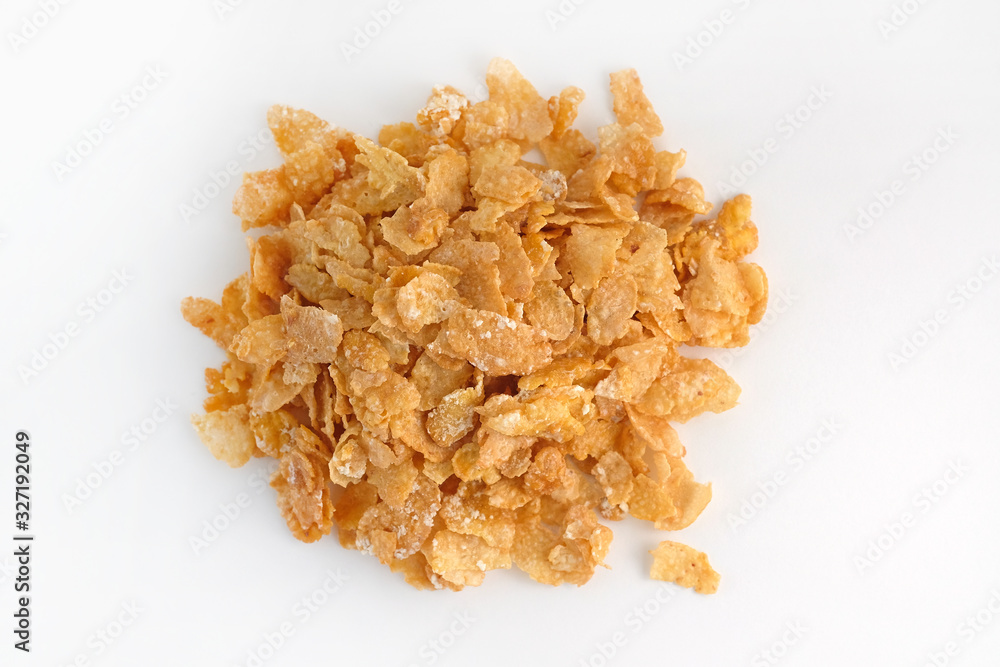 Dry corn flakes top view. Thin cornflakes in glaze on a white background. Quick breakfast cereals.