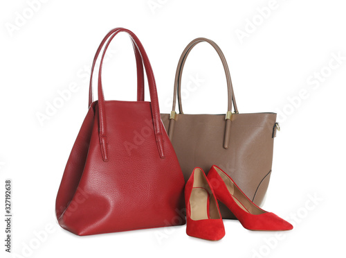 Different stylish woman's bags and shoes isolated on white