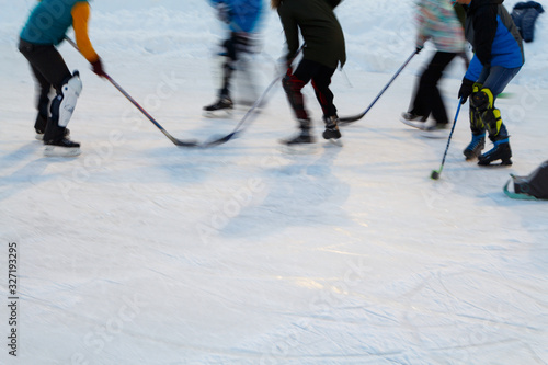 Blurred image of people playing hockey in winter.