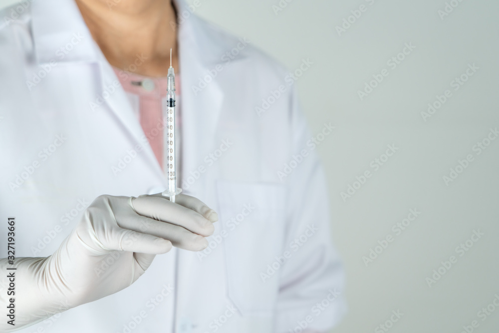 senior doctor or physician hold syringe in the hospital. Concept Of Medical Technology and Healthcare Business senior doctor or physician hold syringe in the hospital. Concept Of Medical Technology and Healthcare Business