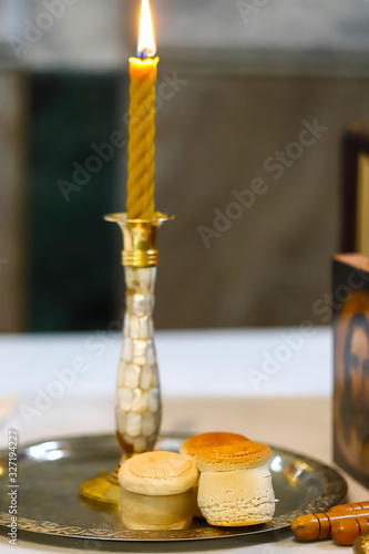 The liturgical liturgical bread of Prosphorus  Prosphora used during Orthodox worship. Preparation for Holy Communion. hands of the priest  icons placed on the altar of the Orthodox Church. The concep