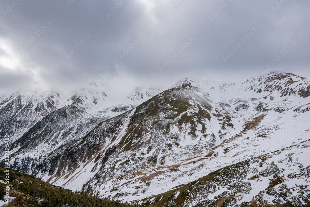Partly snowy mountains with cloudy sky, slovakia low tatras, polana Partly snowy mountains with cloudy sky, slovakia low tatras, polana
