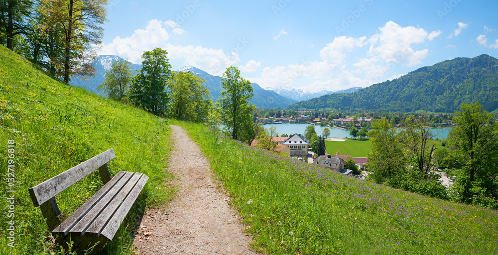 idyllic viewpoint Leeberg hill, above lake tegernsee, recreational area with bench and flower meadow, at springtime. landscape bavaria