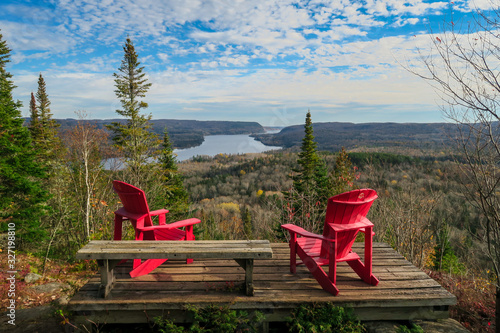 Two iconic red chairs facing the St Maurice river, Mauricie national park photo